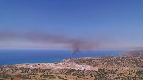 Pollution Impact: Black Smoke Cloud from Chimney Spreading Across the Islands Stock Photos