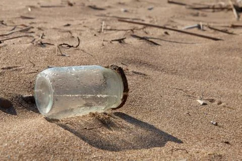 Pollution - jar on beach Stock Photos