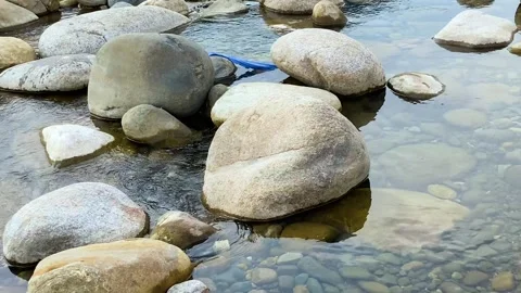 Pollution: Littered soda can polluting rocky river at tourist destination in Vídeo Stock 333350435