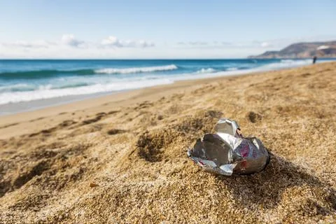 Pollution of the planet with human waste. An empty tin can thrown away by the Stock Photos