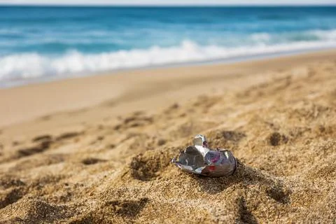 Pollution of the planet with human waste. An empty tin can thrown away by the Stock Photos