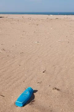 Pollution - plastic can on beach Stock Photos