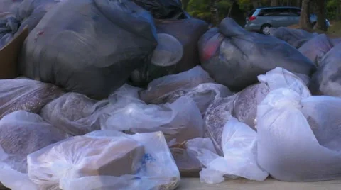 Pollution - Plastic Garbage Rubbish Trash bags left on beach 1 Stock Footage 7764780