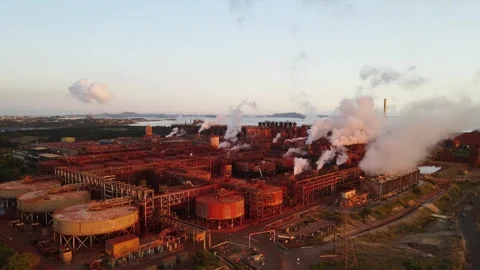 Pollution rising above a sci-fi style industrial landscape refinery plant Stock Footage 329099280
