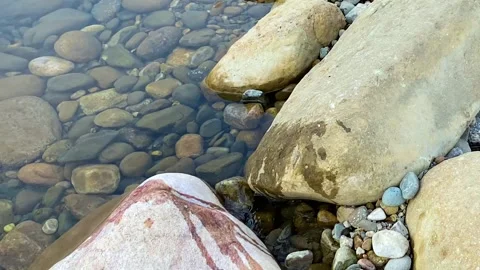 Pollution: Tranquil rocky river polluted by floating soda can left by tourist Vídeo Stock 333779561