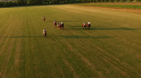Polo challenge during sunset. Jockeys chasing the ball. Slow motion. Aerial N. Stock Footage 64635100