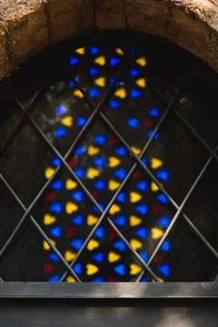 A polychrome stained glass window is a composition made with colored glass. Stock Photos