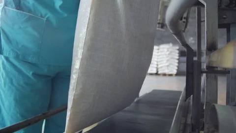 In a polyethylene bag pasta is put on, workers pack macaroni Stock Footage 75217538