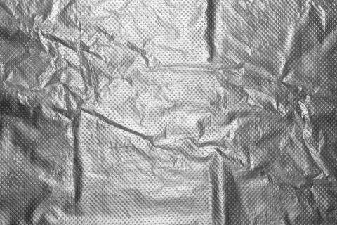 Polyethylene crumpled background to the point.Plastic texture. Stock Photos