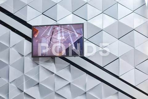 Polygonal futuristic white wall with plasma TV Stock Photos