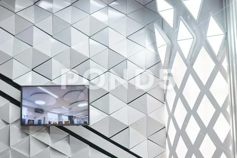 Polygonal futuristic white wall with plasma tv Stock Photos