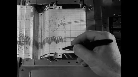 A Polygraph Examiner conducts a test of a suspect and he discovers a lie and a Stock Footage 79524370