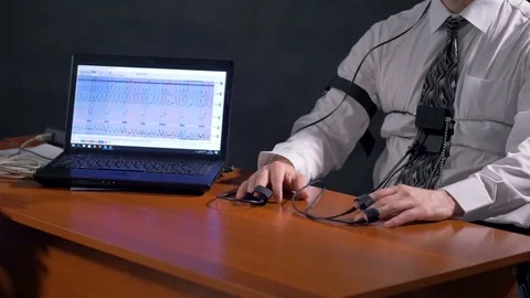 Polygraph subject hands lying calmly beside a laptop. Stock Footage 76748800