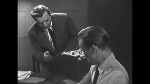 A polygraph technician interrogates and monitors a polygraph test of a jewelry Stock Footage 157263831