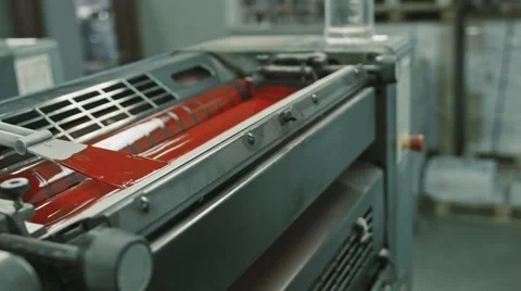 Polygraphy printing industry - red paint on ink roller, close up Stock Footage 68385890