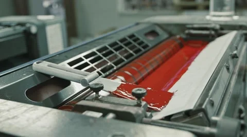 Polygraphy printing industry - red paint on ink roller, extremely close up Stock Footage 68386016