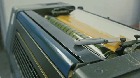 Polygraphy printing industry - yellow paint on ink roller, close up Stock Footage 68385820