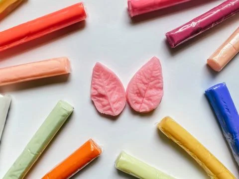 Polymer clay multi-colored and molds for modeling on white background. Creati Stock Photos