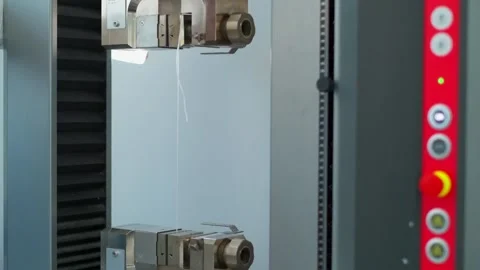 Polymer thread for plastic sack bags is tested for strength in laboratory Stock Footage 202076116