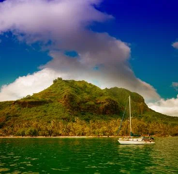 Polynesia Island with pristine waters and blue sky Stock Photos