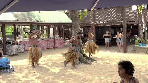 Polynesian men performing traditional Cibi War dance in costumes for tourists Stock Footage 328859891