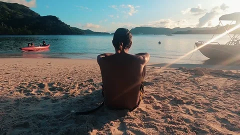 A polynesian reflects on his motu at the edge of the sand Stock Footage 257544843