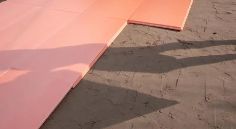 The polyplex polystyrene slab is laid on wet sand as insulation for the Stock Photos