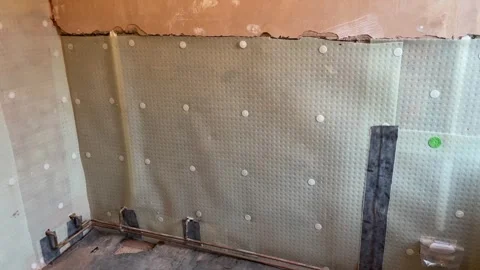 Polypropylene studded seepage membrane to damp-proof wall. Stock Footage 264772773