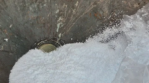 Polystyrene beads pouring into concrete bucket with truck suction hose Stock Footage 340276501