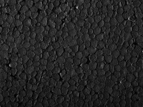 Polystyrene closeup Full frame closeup of a black Polystyrene surface Copy... Stock Photos