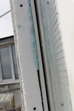 Polystyrene foam is attached to the building facade with blue mounting foam.. Stock Photos