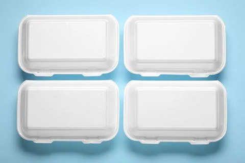 Polystyrene food containers on blue background Stock Photos