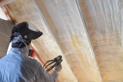 Polyurea Spraying, warming foam coating of roof. Stock Photos
