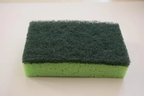 Polyurethane cleaning green sponge isolated on white background. Stock Photos