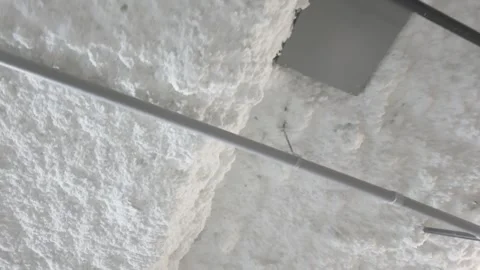 Polyurethane spray foam insulation coating on commercial building ceiling Stock Footage 340155328