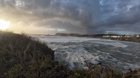 Polzeath Cornwall wild sea from cliffs dramatic surf heavy waves cloudy evening Stock Footage 317840132