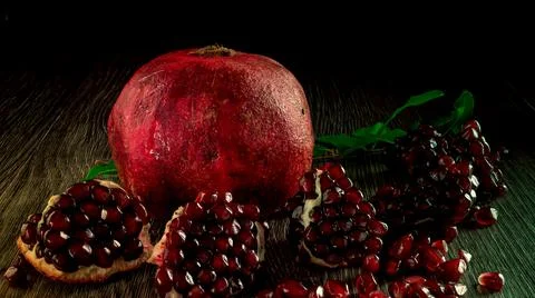 Pomegranate bite breakfast on black background horizontal close-up Stock Photos