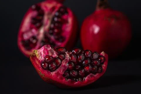 Pomegranate on a black background. Stock Photos