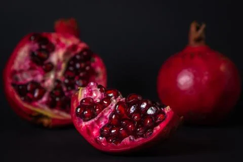 Pomegranate on a black background. Stock Photos