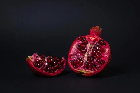Pomegranate on a black background. Stock Photos
