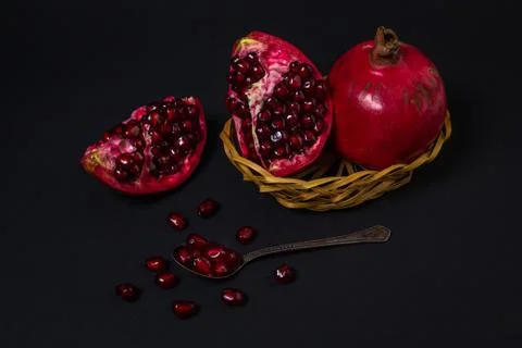 Pomegranate on a black background. Stock Photos