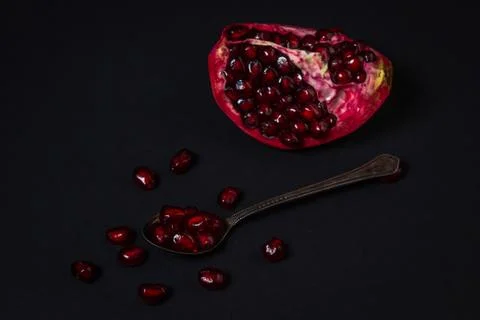 Pomegranate on a black background. Stock Photos