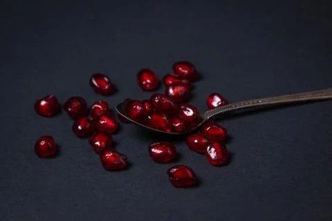Pomegranate on a black background. Stock Photos