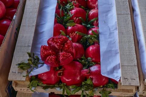 Pomegranate with branches in a box. Stock Photos