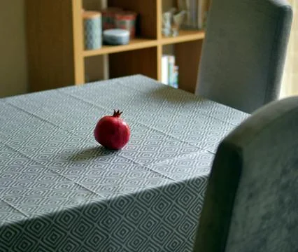 Pomegranate on dining table Stock Photos