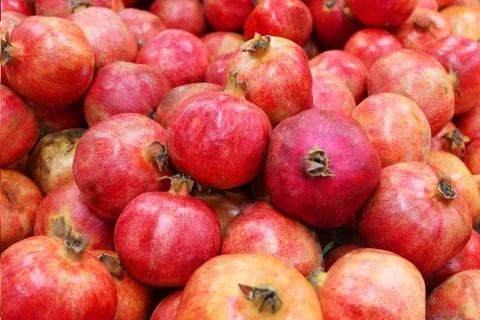 Pomegranate fruit background pattern. Whole pomegranate with flower. Fresh raw Stock Photos