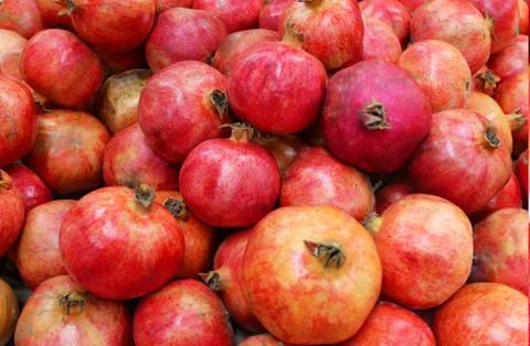 Pomegranate fruit background pattern. Whole pomegranate with flower. Fresh raw Stock Photos