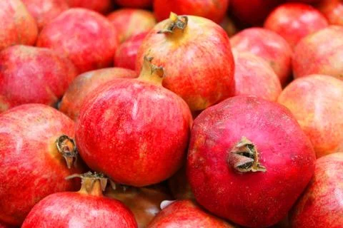 Pomegranate fruit background pattern. Whole pomegranate with flower. Fresh raw Stock Photos