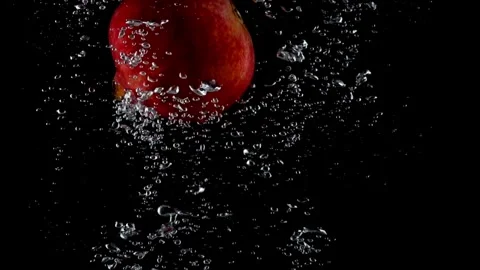 Pomegranate Fruit Falling into Clear Water in Slow Motion  Fresh and Stock Footage 304469413