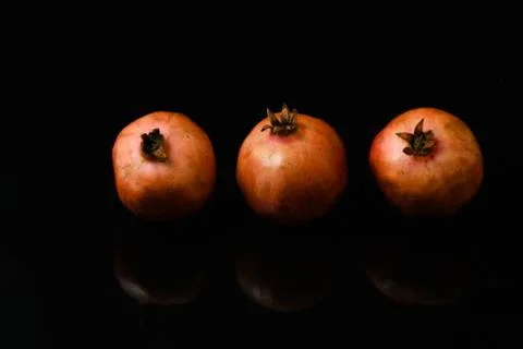 Pomegranate fruit on isolated black background Stock-Fotos
